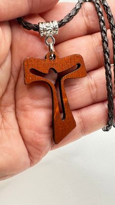 The necklace with the Franciscan Cross is a symbol of the dignity of the children of God, because it is the Cross that has sustained Christ. The Tau "T" is the last letter of the Hebrew alphabet. ... The meaning given to the Tau Cross is similar to that of the Latin Cross. It represents Christian devotion, a sign of penance, redemption and protection from God and redemption in Christ. It is a perfect gift for every Christian PRODUCT DETAILS: This leather necklace measures 20 inches long, or you can choose the size you need, the wooden cross measures 1.7 inches, if you want another size I will gladly do it, please send me a message with the measurement you need, it will be an honor work for you!! All our pieces are completely handmade so there may be a small difference between them, no two Adjustable Cross Pendant Necklace As Gift, Adjustable Pendant Cross Necklace Gift, Brown Jewelry Gift For Father's Day, Symbolic Necklace For Father's Day Gift, Symbolic Cross Necklace As Gift, Symbolic Cross Necklace Gift, Symbolic Cross Pendant Necklace As Gift, Symbolic Crucifix Cross Necklace As Gift, Brown Cross Pendant Necklace As Gift