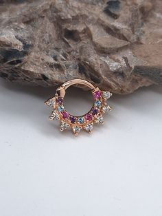 This beautiful star bright septum is a stunning piece of jewelry crafted from high-quality 14k gold and adorned with sparkling white diamonds and Rainbow Stone 8mm-16g White Diamonds : 1.8mm - G - VS2 Diamonds - 0.20ct Inner Rainbow Stones: 1.6mm. Amethyst,Pink Sapphires,Blue Topaz Inner Diameter; 6mm,7mm,8mm, 10mm Septum ring 18g ,16g , 14g. Materials; 14K solid gold yellow god,rose gold,white gold Custom Piercing Jewelry Diamond White Huggie Jewelry With Sparkling Stones, Diamond White Huggie Earrings With Sparkling Stones, Diamond White Sparkling Stones Huggie Jewelry, Diamond White Sparkling Huggie Jewelry, Unique Round Jeweled Jewelry, Fine Jeweled Round Jewelry, 14k Gold Jewelry With Sparkling Round Cut Stones, Celestial Diamond Jewelry With Sparkling Stones, Gift Diamond Accented Round Piercings