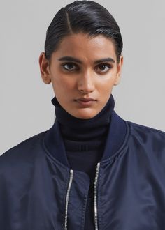 Color: Navy Lightweight technical fabric Oversized silhouette Midi length Baseball collar Padded shoulders Rib-knit cuffs Side flap pockets Zip pocket on sleeve Front zip closure Unlined 100% Polyamide Dry Clean By The Frankie Shop. Imported Navy Outerwear With Ribbed Cuffs For Fall, Navy Outerwear With Ribbed Collar For Fall, Blue Ribbed Collar Outerwear For Work, Workwear Turtleneck Outerwear With Ribbed Cuffs, Navy Winter Outerwear For Layering, Navy Outerwear For Winter Layering, Oversized Blue Utility Jacket, Oversized Blue Outerwear With Pockets, Blue Oversized Utility Jacket