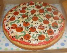 a large pizza in a box on top of a wooden table with polka dot paper