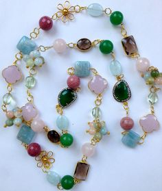 "This spectacular long multi gemstone statement necklace is a whimsical fun fantasy piece handmade and designed by me.  It is made  with 14K gold filled wire and chain, 24K vermeil flower connectors, and links, onto which I carefully wire wrapped the finest quality semi precious gemstones in spring pastel colors, including Flower clusters of Beryl, Rose Quartz faceted rounds, rhodonite faceted rounds,bezel set smokey quartz connectors, 24K gold vermeil connectors in two distinct shapes, square s Crazy Necklaces, Green Statement Necklace, Multi Gemstone Necklace, Freshwater Pearl Drop Earrings, Bijoux Fil Aluminium, Diy Jewelry Necklace, Handmade Fine Jewelry, Wire Necklace, Quartz Beads