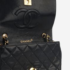 Sleek, refined and effortlessly chic, the vintage mini full flap bag embodies Chanel’s non-traditionally feminine aesthetic. Crafted from soft black lambskin leather and complimented by gold plated hardware, there is nothing more beautiful than this. SPL Exterior Black quilted lambskin leather Gold plated hardware CC turn-lock closure Interwoven chain strap 1989-1991 production Great vintage condition - some rubbing to the corners and exterior Interior Burgundy leather interior Spacious compartment Two slip pockets Chanel embossed leather logo Great vintage condition - press marks and scratching to interior Sold with ity card SPL Height 11cm Width 19cm Depth 6cm Vintage Double Flap Bags With Gold-tone Hardware, High-end Black Flap Bag With Gold-tone Hardware, Chanel Vintage Classic Flap, Chanel Vintage Single Flap Bag, Chanel Vintage Classic Double Flap Bag Quilted Lambskin Medium, Black Quilt, Feminine Aesthetic, Chic Me, Leather Interior