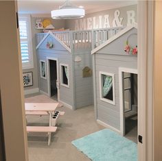 a child's room with bunk beds and a play house in the corner,