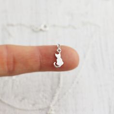 Tiny Sterling Silver Sitting Cat Necklace. This charm necklace featuring a sweet kitty sitting patiently with a tiny curled tail is just the thing for animal lovers. Take this little cat home with you and it will be sure to bring a smile to your face and warmth to your heart! » Sterling Silver Cat Charm (15mm x 6mm) with tiny 925 genuine Sterling mark on back. » Sterling Silver Cable Chain (select from drop-down on upper right) » Your jewelry purchase will come beautifully packaged for gift givi Cat Necklace Gold, Cat Charm Necklace, Lovers Jewelry, Cat Necklace Silver, Lover Necklace, Cat Pendant Necklace, Pet Jewelry, Pendant Necklace Simple, Sweet Kitty