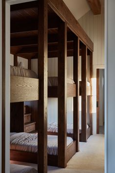 bunk beds are lined up in the corner of a room with carpeted flooring