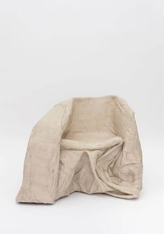 a white chair covered with a cloth on top of it