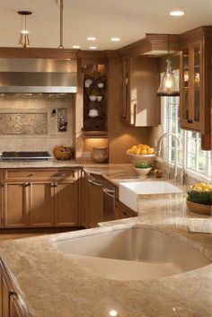 a kitchen filled with lots of counter top space next to a sink and stovetop oven