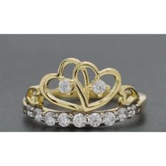 two heart shaped rings with diamonds on each one and the other side, set in yellow gold