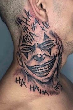 a man's neck with an evil clown tattoo on it