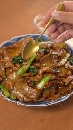 a person is spooning some food on a plate