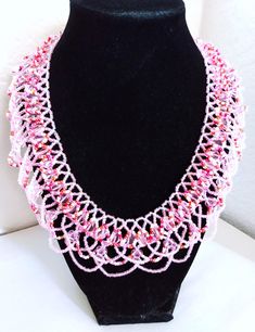 A handmade glass beaded necklace that is perfect for any occasion: parties, holidays, birthdays, anniversaries. All products are hand-crafted by my mother. Dimensions: - Actual Length: 24.1 cm - Collar Length: 20.5 cm - Width: 18.2 cm - Height: 2.0 mm Lightweight, high quality with a beaded hook as a clasp.  Acrylic Pearls: 8 mm. Will respond to concerns and suggestions promptly. Shipping costs: Free Domestic Shipping. All orders are sent by air-mail with tracking number. Time of delivery: Estimated 1-3 days for domestic shipping; international make take 7-14 days. Feel free to check out our other similar products! Link: https://noorsjewelers.etsy.com Handmade Pink Crystal Necklaces With Round Beads, Handmade Pink Crystal Bead Necklace, Handmade Beaded Necklaces With Round Beads For Celebration, Pink Czech Glass Necklaces With Colorful Beads, White Bohemian Beaded Necklaces For Celebration, White Bohemian Beaded Necklace For Celebration, Pink Beaded Necklaces With Round Beads For Crafting, Handmade Beaded Bracelets With Round Beads For Celebration, Round Bead Caps Necklace Perfect For Gifts