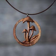 a wooden pendant with two mushrooms on it