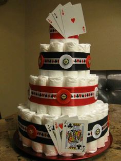 a diaper cake made to look like a casino card tower with cards on top