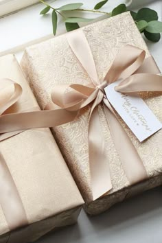 three wrapped gift boxes with ribbons tied around them