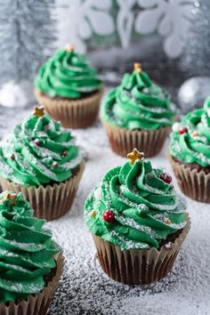 cupcakes with green frosting and christmas decorations