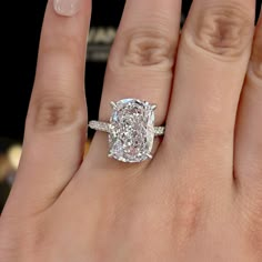 a woman's hand with a diamond ring on it