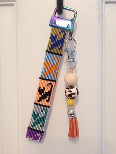 a beaded key chain hanging on a door