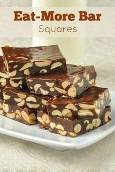 chocolate peanut butter bars stacked on top of each other with the text, eat more bar squares