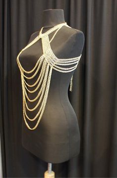 Here's a great and totally unique body chain necklace that makes the old 'little black dress' take on a whole different meaning! This gold body chain as I like to call it, adds the perfect amount of deco to your once all too simple party dress. It also looks great worn over a loose shirt, with jeans, conforming to the body in all the right places. Its great for a cocktail party or a night out at the clubs, this is definitely an attention grabbing piece. Would you like to see more body chain jewe Bohemian Body Jewelry With Chain For Festivals, Bohemian Chain Body Jewelry For Festivals, Bohemian Festival Body Jewelry With Chain, Gold Bohemian Body Chain For Festivals, Bohemian Gold Body Chain For Festivals, Gold Adjustable Body Chain For Festivals, Adjustable Festival Body Chain, Gold Metal Waist Chain For Festival, Gold Festival Body Jewelry With Chain