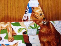 a close up of a bag on a table with a cat and dog print pattern