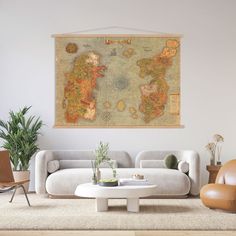 a living room filled with furniture and a large map hanging on the wall above it