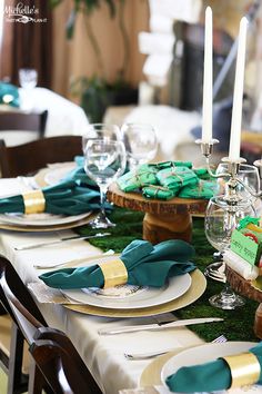 the table is set with green and gold place settings