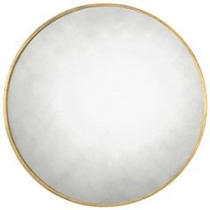 a white and gold circular mirror on a wall