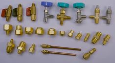 many different types of brass fittings and tools