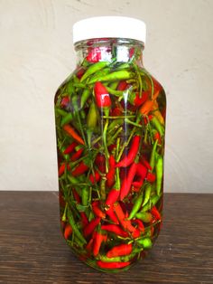 a jar filled with red and green peppers