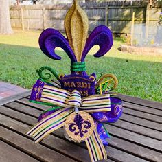 a mardi gras decoration on top of a wooden table