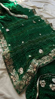 Welcome to our exquisite collection of Green Bhandej Saree, perfect for those special occasions like weddings, parties, and festive gatherings. This Bollywood-style saree is crafted with utmost care and attention to detail, ensuring a premium quality product that you will adore. The saree comes with a matching unstitched blouse piece, adding to its versatility and charm. The beautiful fall and edging are already done, giving the saree an elegant drape. You have the option to choose tassels for an extra touch of grace and style. Saree Details: Saree Color: Green Bhandej Saree Length: 5.5 meters Blouse Piece Length: 0.8 meters Wash Instruction: Dry Clean Only *Please note that the petticoat and ready to wear saree options are available upon request with additional charges. Whether you want t Traditional Bandhani Print Sharara In Georgette, Unstitched Bandhani Print Pre-draped Saree For Weddings, Traditional Bandhani Print Lehenga In Georgette, Gota Work Saree For Traditional Ceremonies, Wedding Bandhani Print Traditional Wear In Georgette, Semi-stitched Saree With Gota Work For Traditional Ceremonies, Semi-stitched Gota Work Saree For Traditional Ceremonies, Wedding Bandhani Print Saree In Traditional Drape, Unstitched Bandhani Print Salwar Kameez For Wedding