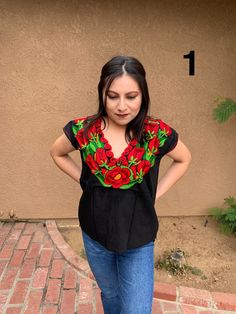 Beautiful Mexican Top that is full of embroidered florals that will make you stand out at any event. This blouse is embroidered by artisanal machine in the State of Puebla and is completely one of a kind! Each blouse is unique in its own way. Size: Small/Medium Multicolor Embroidered Floral Print Short Sleeve Blouse, Traditional Short Sleeve Blouse With Floral Embroidery, Short Sleeve Floral Embroidered Festival Top, Folk Style Short Sleeve Blouse With Floral Print, Festival Floral Embroidered Short Sleeve Top, Festival Short Sleeve Embroidered Top, Festival Short Sleeve Top With Embroidered Neckline, Short Sleeve Tops With Embroidered Neckline For Festivals, Festival Embroidered Top With Short Sleeves