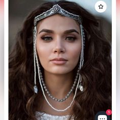 a woman with long brown hair wearing a head piece and pearls on it's face