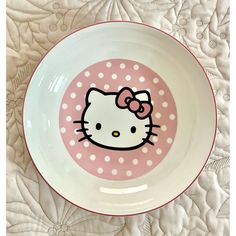 a bowl with a hello kitty design on the side and polka dots around the rim