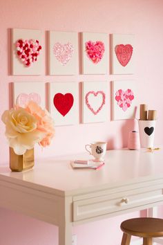 a white desk topped with lots of pink hearts