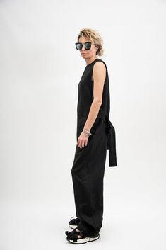 Who's the freshest of them all? It's you in the Black linen jumpsuit women! This sleeveless jumpsuit features, sides cut out, tie waist belt included, two front pockets and flowy wide leg pants. This linen clothing is designed to flatter every body type. When we designed this Black linen jumpsuit women, we focus on the versatility of each model to make it a perfect match for your favorite accessories and wardrobe pieces. Perfect for slaying in the streets, pair this Black overalls women with a l Casual Relaxed Fit Maxi Jumpsuits And Rompers, Casual Maxi-length Relaxed Fit Jumpsuits And Rompers, Black Cotton Jumpsuit For Summer, Black Maxi Length Casual Jumpsuits And Rompers, Spring Wide-leg Black Jumpsuits And Rompers, Spring Black Wide-leg Jumpsuits And Rompers, Black Wide Leg Jumpsuits And Rompers For Spring, Relaxed Fit Maxi Length Jumpsuits And Rompers, Black Relaxed Fit Wide Leg Jumpsuits And Rompers