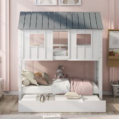 a white bunk bed with pink walls and wooden flooring in a child's room