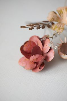 an arrangement of flowers on a white surface