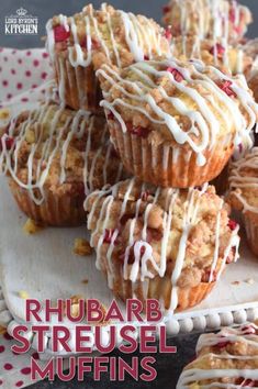 muffins with white icing and cranberries on a plate