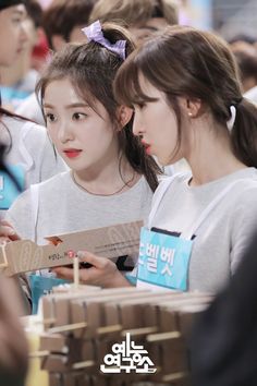 two girls are looking at something in front of them