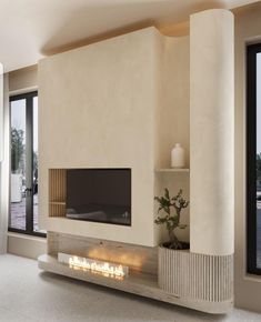 a modern living room with a fireplace and large glass doors that open to the outside