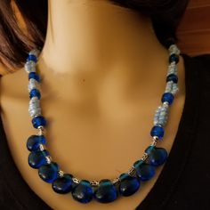 Handcrafted By Carolle Made With Glass Be And Stainless Steel Beads And Clasp Blue Faceted Glass Beads, Blue Glass Faceted Beads, Blue Czech Glass Beaded Chain, Blue Glass Beads For Jewelry Making, Blue Glass Beaded Bohemian Necklace, Blue Glass Bohemian Beaded Necklaces, Bohemian Blue Glass Beaded Necklaces, Elegant Blue Beaded Necklace With Dangling Beads, Elegant Handmade Blue Beads