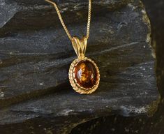 Gold Amber Pendant set with Natural Amber in the highest quality & brownish-yellow translucent resin, at 10x8mm, 3 Carats, sourced from Russia. Gold Dainty Pendant in Vintage design made of Gold Vermeil ☞ thickest 18k Gold Plating on top of Solid 925 Sterling Silver ☞ made to last. Free Gold Vermeil Chain with every Pendant order, 18 inch Silver chain (46 cm) ✓ Matching Ring & Earrings - please ask me ⌛Last Pendant left ⌛ ❀ Each Natural Gem is unique & will have Slight variations from the produc 14k Gold Oval Amber Jewelry, Polished 14k Gold Amber Jewelry, 14k Gold Amber Jewelry With Polished Finish, Classic 14k Gold Amber Jewelry, Oval Amber Gemstone Jewelry, Oval Amber Birthstone Jewelry, 14k Gold Amber Round Jewelry, Fine Jewelry Amber Jewelry For Formal Occasions, 14k Gold Round Amber Jewelry