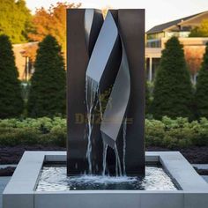 a water fountain in the middle of a garden