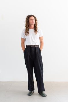 These workwear cotton twill pants feature the following: metal button fly, high rise, belt loops, coin pocket, front pockets, back pockets with darts. Semi-Wide straight leg. These were originally white workwear chinos, now dyed black. Unisex Fit so the hips are more narrow than modern women's pants. The material is a thick canvas cotton. These originally had buttons on the interior of the waistband for suspenders. Material: 100% Cotton Canvas - thick | Made in the USA in the 60s. Garment Dyed in Los Angeles in 2022. Condition: Great. A couple marks with metal residue.   Measurements: 36" Waist / 47" Hips / 14" Rise / 14.25" Thigh / 9.75" Leg Opening / 31.5" Inseam Elijah is 6'0" with a 30" waist. This could fit a larger frame. SHOP http://www.rawsonstudio.etsy.com FOLLOW US + instagram | Workwear Chinos, Pant Trouser, Utility Pants, Fly High, Twill Pants, Metal Buttons, Suspenders, Modern Woman, Women's Pants