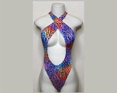 Welcome to my shop Let's Make Money Together 💕 DETAILS  * Handmade Item  * Materials: Nylon, Spandex * Crossover Bodysuit  * Never used  DESCRIPTION  * Thong Bodysuit  * Multicolored Cheetah Print Spandex * 4 way stretch Fabric  * Mannequin is wearing XS/Small (may choose sizing at checkout)   SHIPPING  My current shipping turnaround is really quick 1 to 2 days  RETURNS & EXCHANGES  No refunds or exchanges if you have any issues with your purchase please feel free to reach me personally. I can Festival Fitted One-piece Bodysuit, Fitted One-piece Bodysuit For Festival, Summer Rave Fitted Leotard, Multicolor Bodysuit For Club, Fitted Multicolor Bodysuit For Club, Fitted Multicolor Backless Bodysuit, Summer Festival Dancewear Bodysuit, Fitted Rave Bodysuit For Beach, Fitted Rave Bodysuit For The Beach