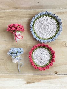 three crocheted dishes are sitting on a wooden surface