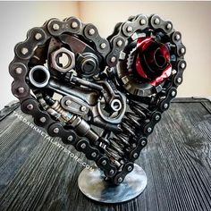 a heart made out of motorcycle parts sitting on top of a table