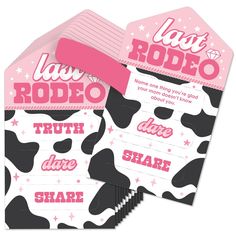 two pink and black cow print tags with the words, i am rodeo on them