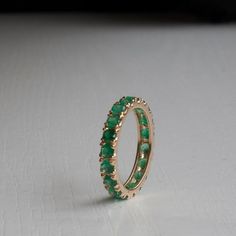 Gorgeous Emerald Eternity ring in your choice of Karat and Gold Color. Featuring between 2.35-2.52ctw (Subject to size). Natural Grade AAA Emeralds with that wonderful sought after green and Very Good clarity. Each ring is made to Order and set with meticulously handpicked Emeralds to ensure the most elegant results. All questions and custom requests welcome!, Fast turn around. ----------------------DIMENSIONS---------------------- This rings shank is 3.4 mm to accommodate the 3 mm Emeralds. The Green Emerald Eternity Ring, Green Eternity Band With Vvs Clarity In Round Shape, Green Emerald Wedding Band, Gold And Emerald Ring, Spain Destination Wedding, Gemstone Wedding Band, Pink And Green Wedding, Emerald Gold Ring, Emerald Eternity Ring